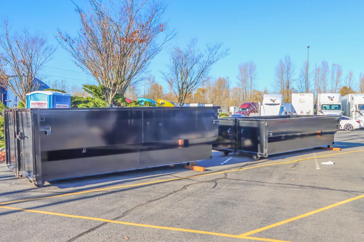Professional dumpster rental service with roll-off container on residential driveway in Kenai